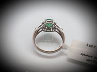 White gold ring with round emerald and diamonds