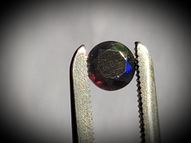 Black rainbow opal 0.50 ct 6 mm