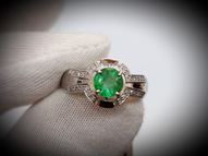 White gold ring with round emerald and diamonds