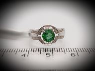 White gold ring with round emerald and diamonds