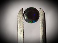 Black rainbow opal 0.50 ct 6 mm