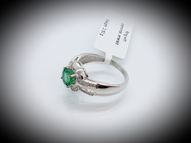 White gold ring with round emerald and diamonds