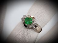 White gold ring with round emerald and diamonds